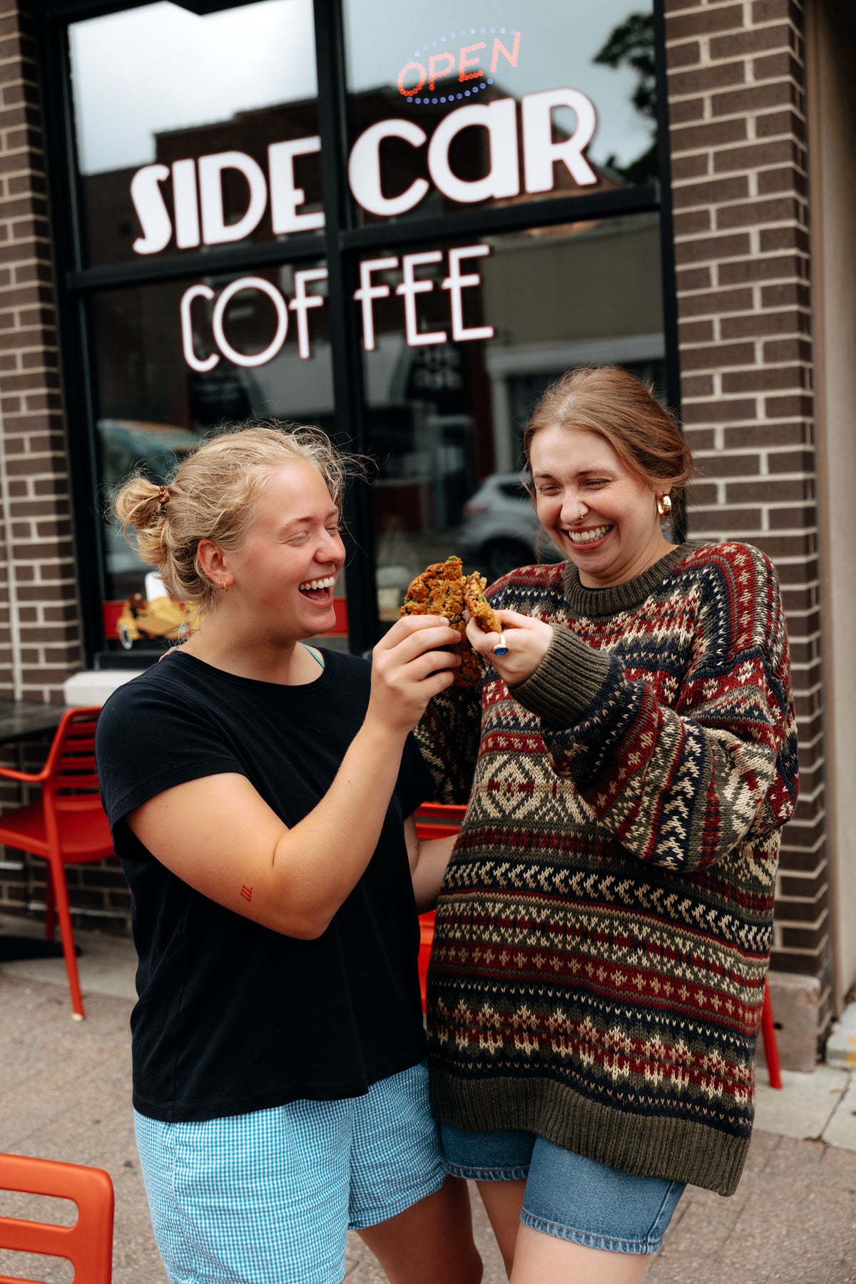 Jul 2025 friends sharing cookie at storefront