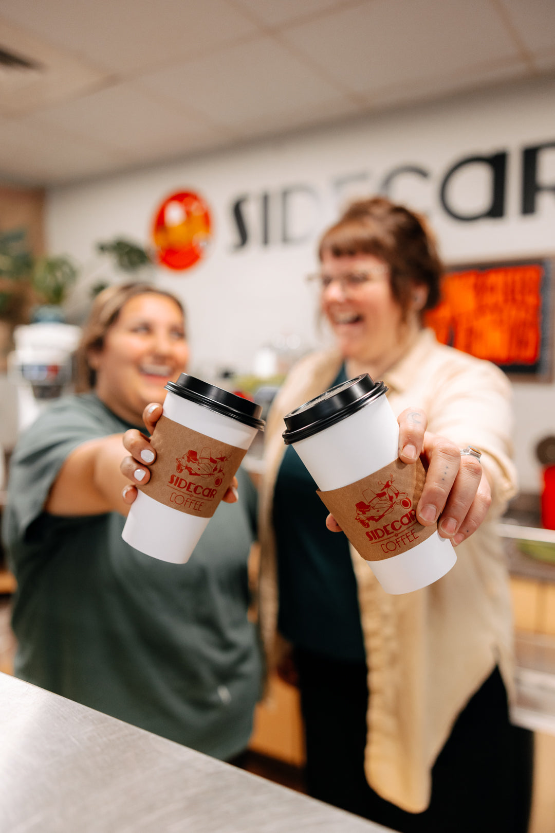 Apr 2026 two baristas cheers with cups